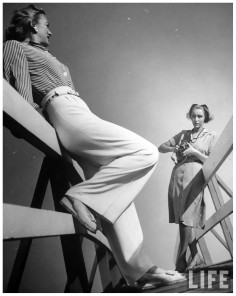 photographer-nina-leen-lining-up-shot-of-fashion-model-who-is-wearing-slacks-posing-casually-in-fore-1954